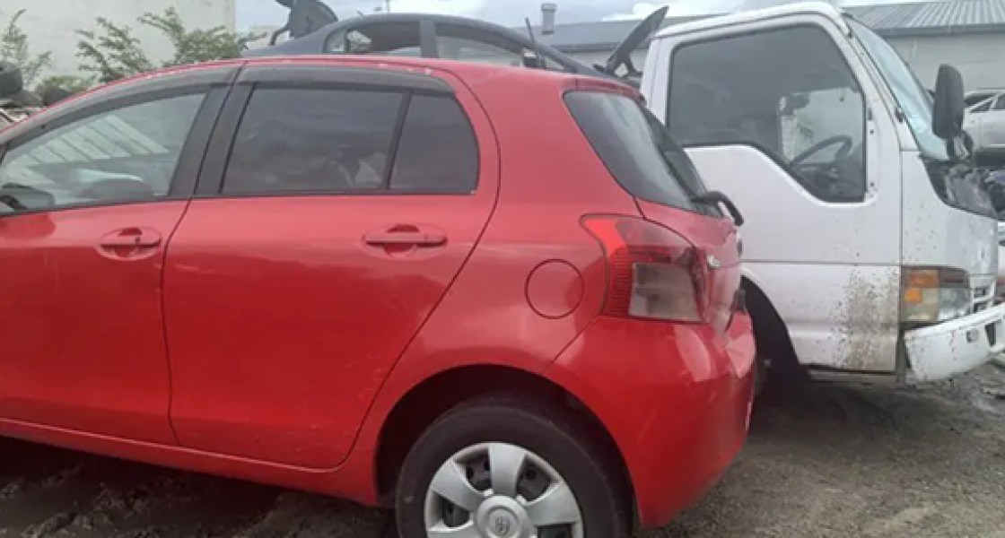 Scrap car being loaded onto a tow truck in Taupo